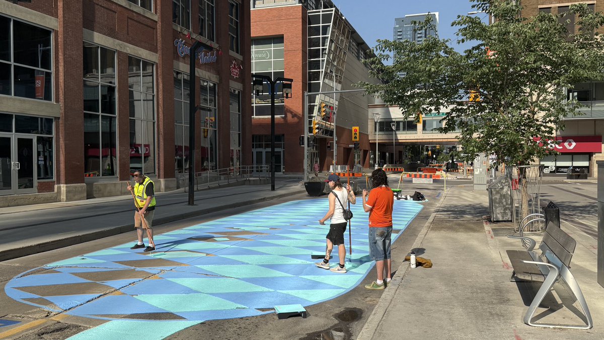 brent_bellamy's tweet image. Really exciting to see Graham Avenue being transformed into Winnipeg’s first permanent pedestrian street. @CoolStreetsWPG is painting the pavement. Planters, furniture and art is being installed - including a giant fan that can be pedaled to cool people off.