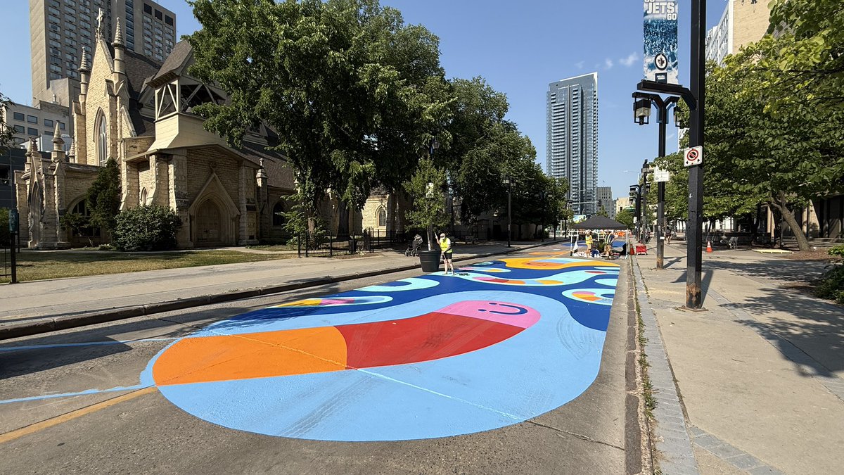 brent_bellamy's tweet image. Really exciting to see Graham Avenue being transformed into Winnipeg’s first permanent pedestrian street. @CoolStreetsWPG is painting the pavement. Planters, furniture and art is being installed - including a giant fan that can be pedaled to cool people off.