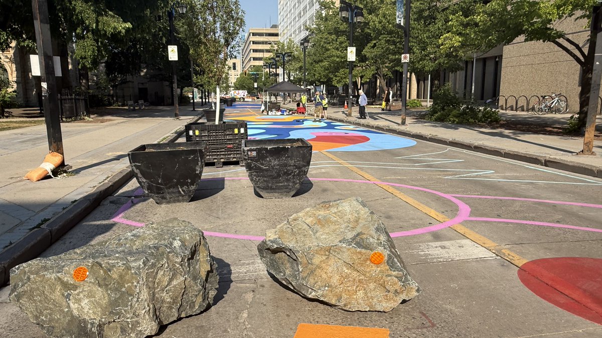 brent_bellamy's tweet image. Really exciting to see Graham Avenue being transformed into Winnipeg’s first permanent pedestrian street. @CoolStreetsWPG is painting the pavement. Planters, furniture and art is being installed - including a giant fan that can be pedaled to cool people off.