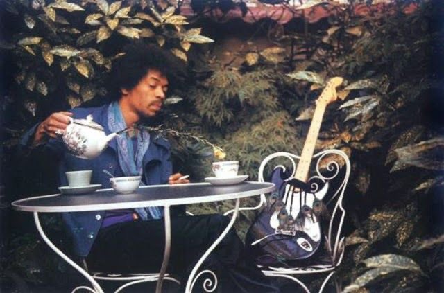 Jimi Hendrix drinking tea with his Stratocaster. This photo was taken one day before his passing.