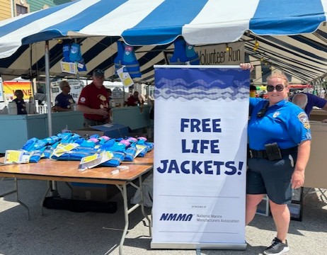 NMMA teamed up with the Pewaukee Police Department to promote boating safety, distributing free life jackets at the annual Pewaukee Kiwanis Beach Party. The free event was well-attended, with adults &amp; children in the community properly fitted to receive a free life jacket,