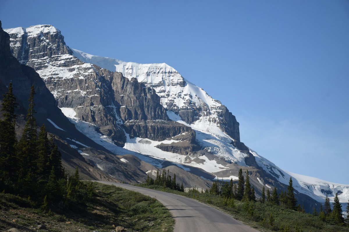I wanna go Cody WY Snow Covered Mountain Under Blue Sky.