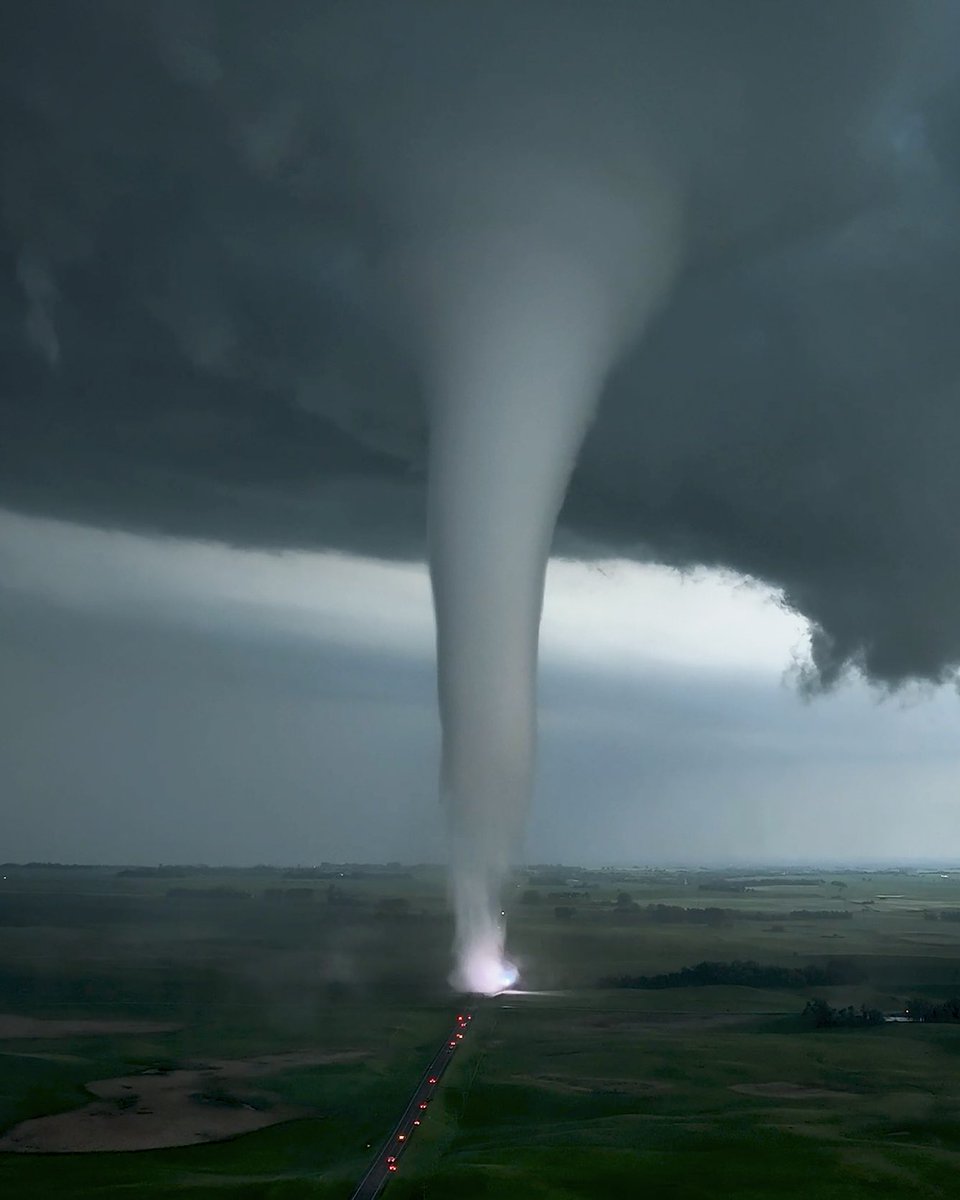 twisterhunters's tweet image. Power flash illuminating the base of a tornado as it crossed the road on Saturday in South Dakota