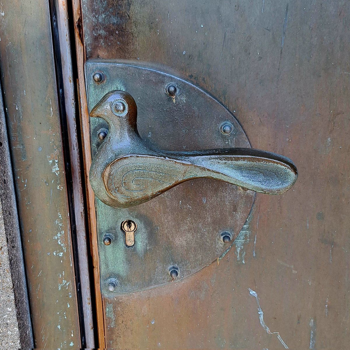 En dan valt je oog op de deurklink van de plaatselijke kerk #vredesduif