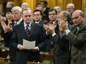 Prime Minister Jean Chretien receiving a standing ovation from his caucus after announcing Canada would not participate in a war on Iraq on March 17, 2003. credit: National Post