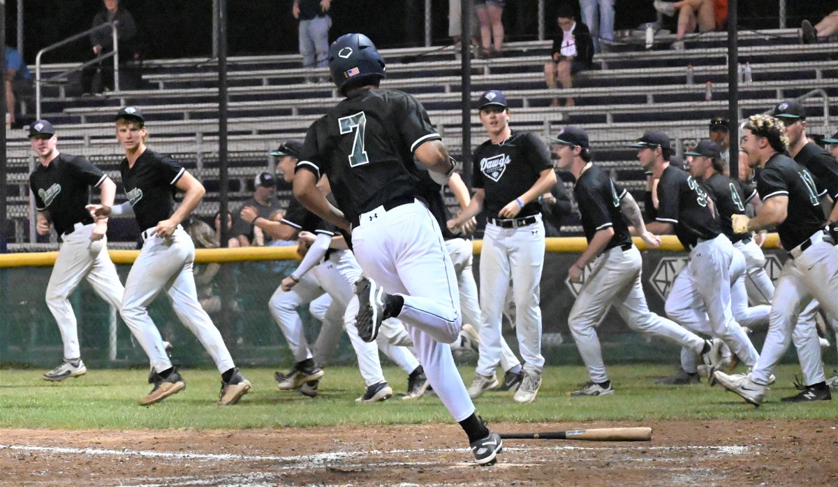 Joey Calabretti delivers the winning hit.
Sean Stoney (7) steps on the plate as the DiamondDawgs pour out of the dugout and chase Calabretti to celebrate.