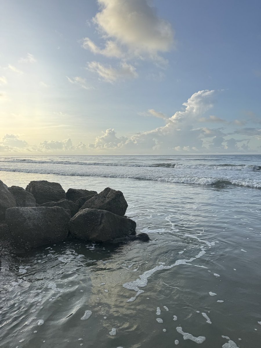 Ocean blankets the rock wall - Folly Beach