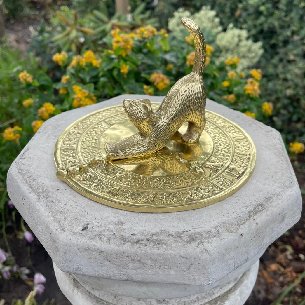 (Amanda) Look what a very kind Follower sent us! It's called a 'sundial' and it helps humans to tell the time. 
Pip put it in the Memorial Garden yesterday, just next to Ken's bench.
It's good to have a special place for special things, isn't it?