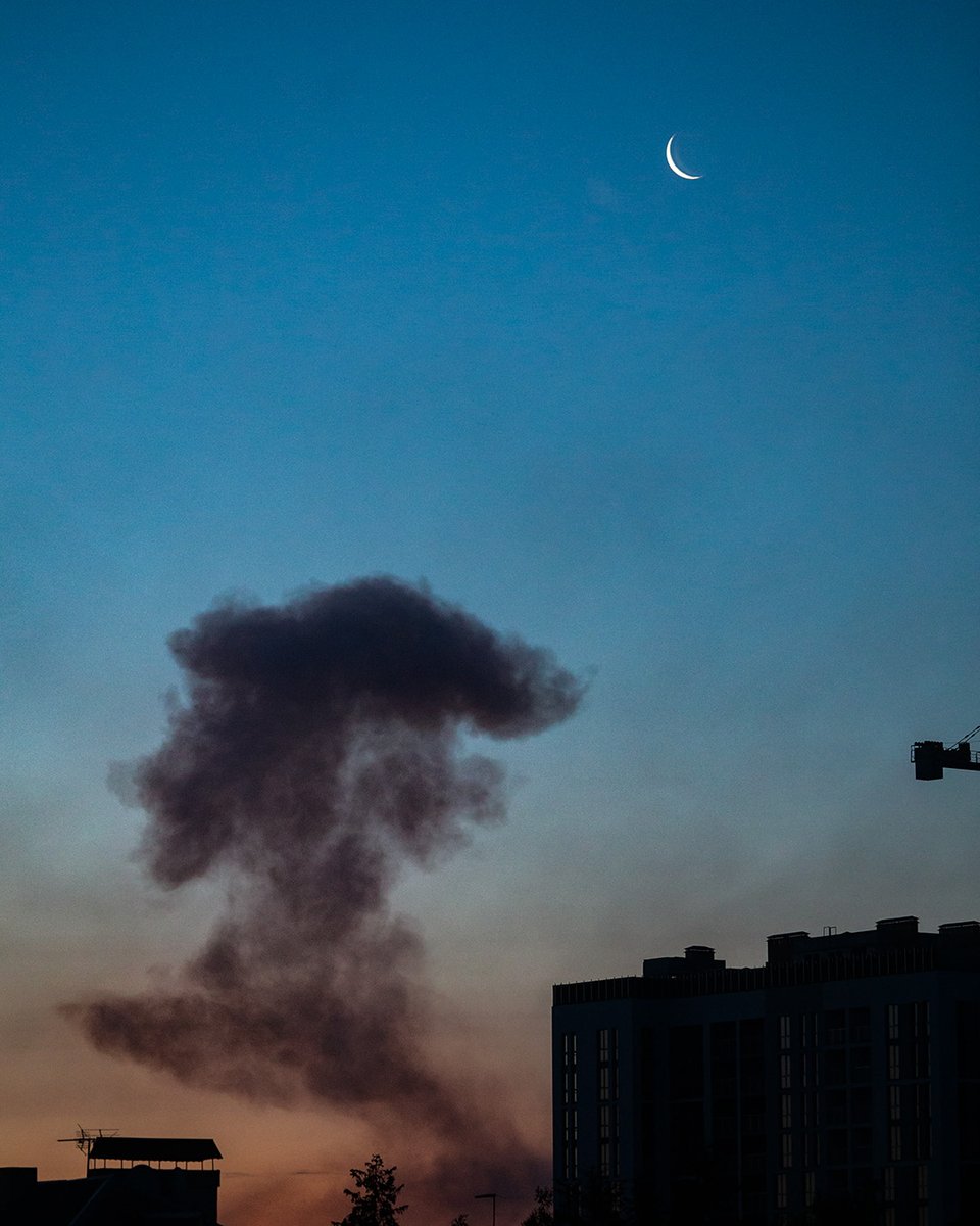 Crescent moon over smoke-filled Kyiv sky after this morning's missile and drone attack