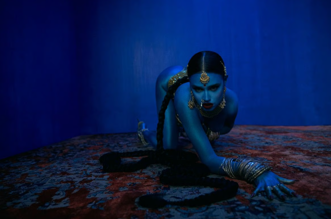 PakshForBharat's tweet photo. 🟥 Tommy Genesis Slammed for Dressing as Goddess Kali & Licking Crucifix in New Music Video

Canadian rapper Genesis Yasmine Mohanraj (aka Tommy Genesis) faces a massive online backlash for her provocative music video True Blue. 

In the clip, she's painted blue with Hindu goddess Kali imagery sparking accusations of cultural appropriation and blasphemy from both Hindu and Christian communities.

#TommyGenesis #CulturalAppropriation #Blasphemy #TrueBlue #ReligiousRespect
