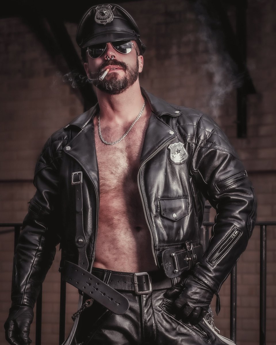 MASTER SMOKING IN LEATHER GLOVES.