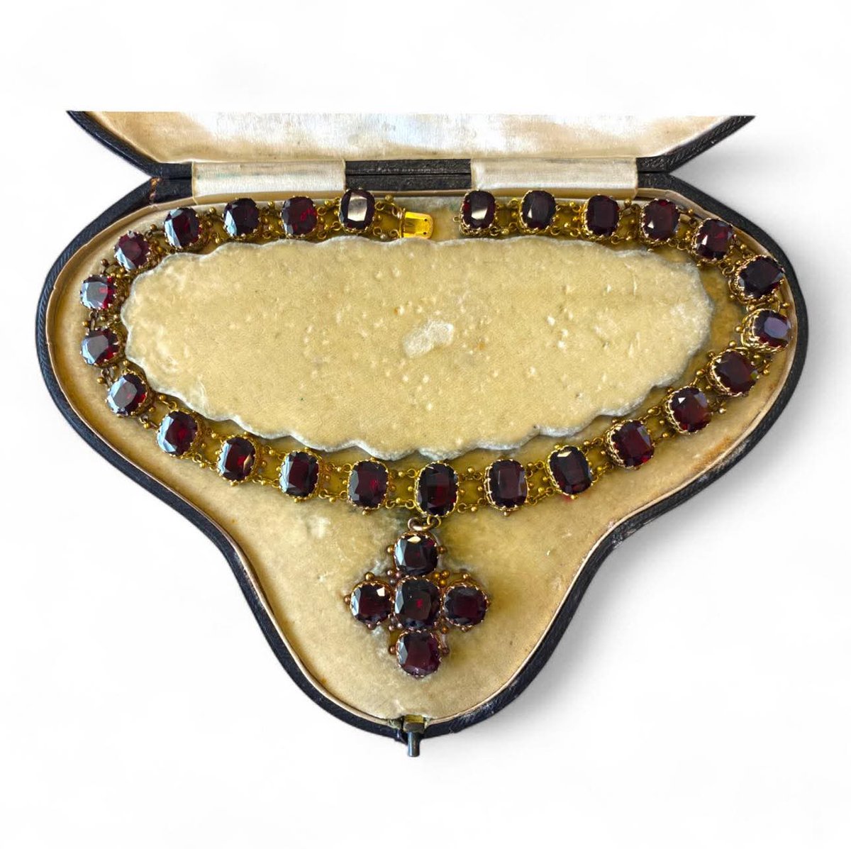 Lot 42 In Our Friday 4th July Auction

An impressive Victorian 19th Century Garnet Cross Rivière Necklace, In Original Fitted Box. Clasp Surface Tested As 9ct Yellow Gold.

18 inches long, with cross drop pendant approx 1.5 inches,
Weight approx 66.6g.

£500-800