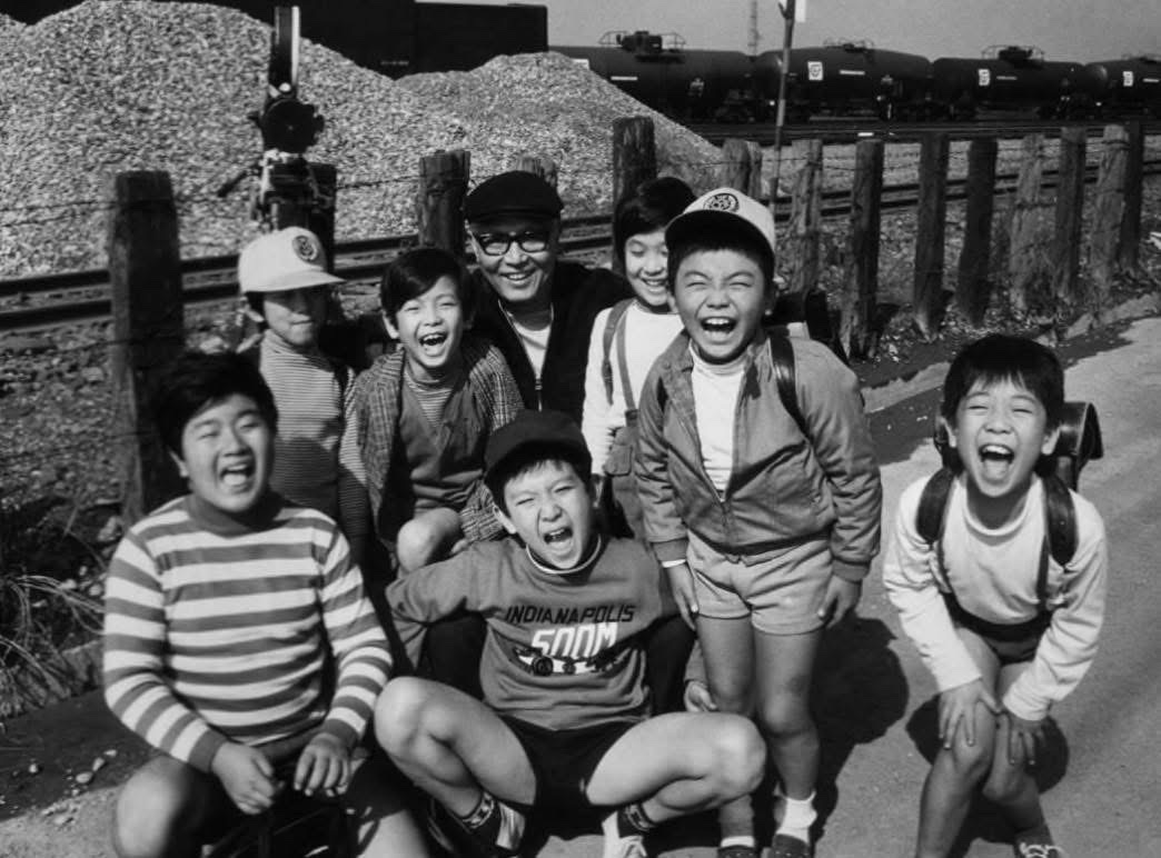 Ishiro Honda poses with the kiddo cast of ALL MONSTERS ATTACK (1969).

The film was shot in the heavily congested city of Kawasaki the same year an estimated 16,765 Japanese pedestrians (many of them latchkey children walking to and from school) died in traffic accidents.