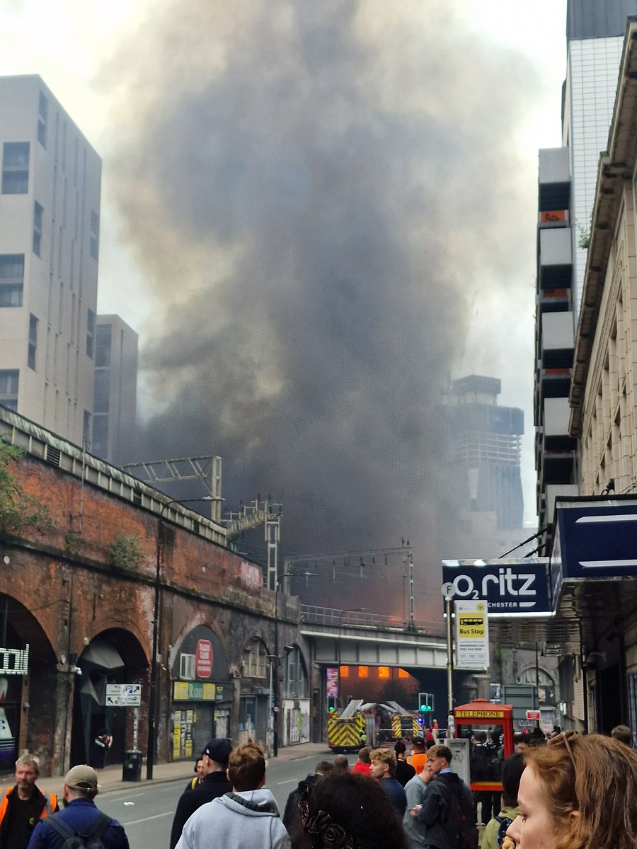 oschmidthansen's tweet photo. Part of roof collapsed and smoke and ash blowing eastwards towards picadilly/ardwick https://t.co/7aH3t6Nv4u