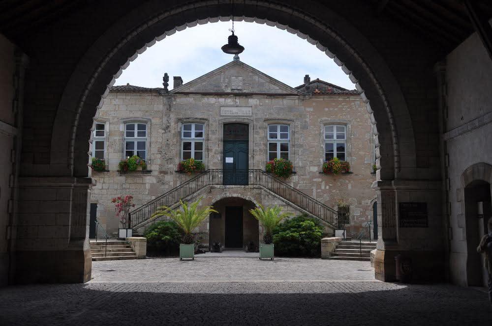 NZAllison's tweet photo. Bezas cathedral. Another of those "prettiest villages" which we saw on our way to the Roquefort, that wasn't.
Council offices from the old covered cattle market. View from the ramparts to the Sultan's Garden below. Old utility building being slowly renovated. 
#Bezas https://t.co/ypanaSVb8e