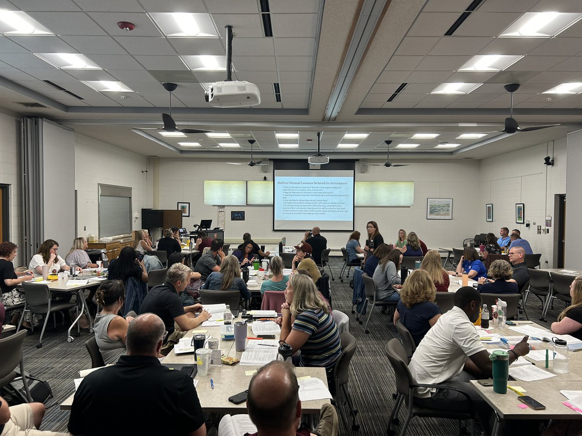 A room full of school teams making plans to tackle attendance challenges next school year.