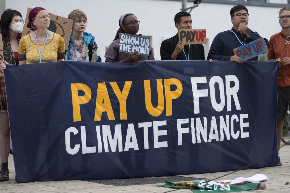 IBONIntlClimate's tweet photo. LOOK: Constituencies gathered for an action outside the #SB62 venue to amplify calls for #climatefinance. Speaking for @gcdcj, IBON Intl denounced the global North’s refusal to deliver, especially on urgently needed funds for #adaptation and #LossAndDamage. 📷 Teo Ormond-Skeaping https://t.co/AgBt5VxkM7
