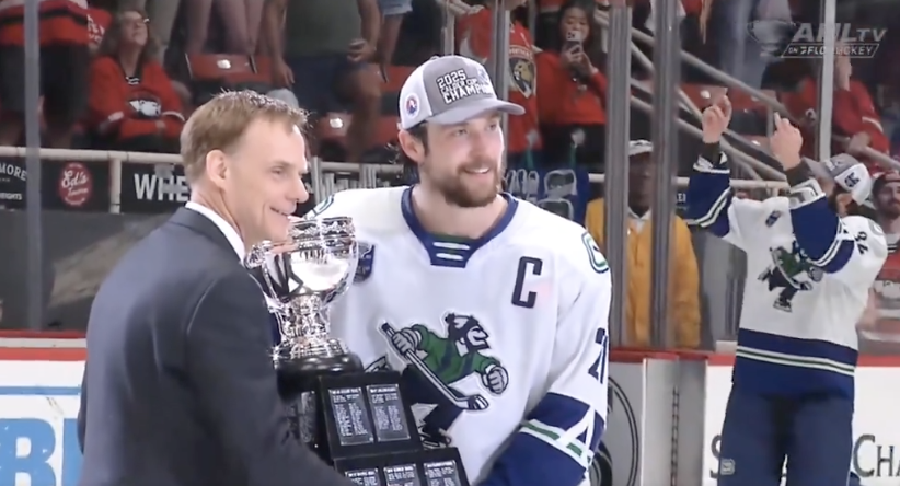 glad the first ever cup handover to anyone in a canucks jersey includes phil di giuseppe in the background flipping off the opposing crowd