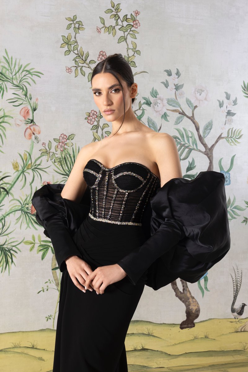 A structured form and intricate detailing define this #RamiKadiCouture black strapless gown, featuring a sheer structured bodice embroidered with crystal wirings and delicate beadings, paired with voluminous satin puff sleeves. 

#RamiKadi #RamiKadiCouture #Cannes2025