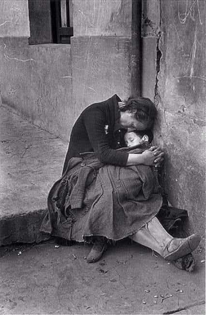 28. A photograph in 1943 in Austria shows pooverty,a mother holding her child hopelessly, nothing to eat , nothing to wear and live and nothing to drink.