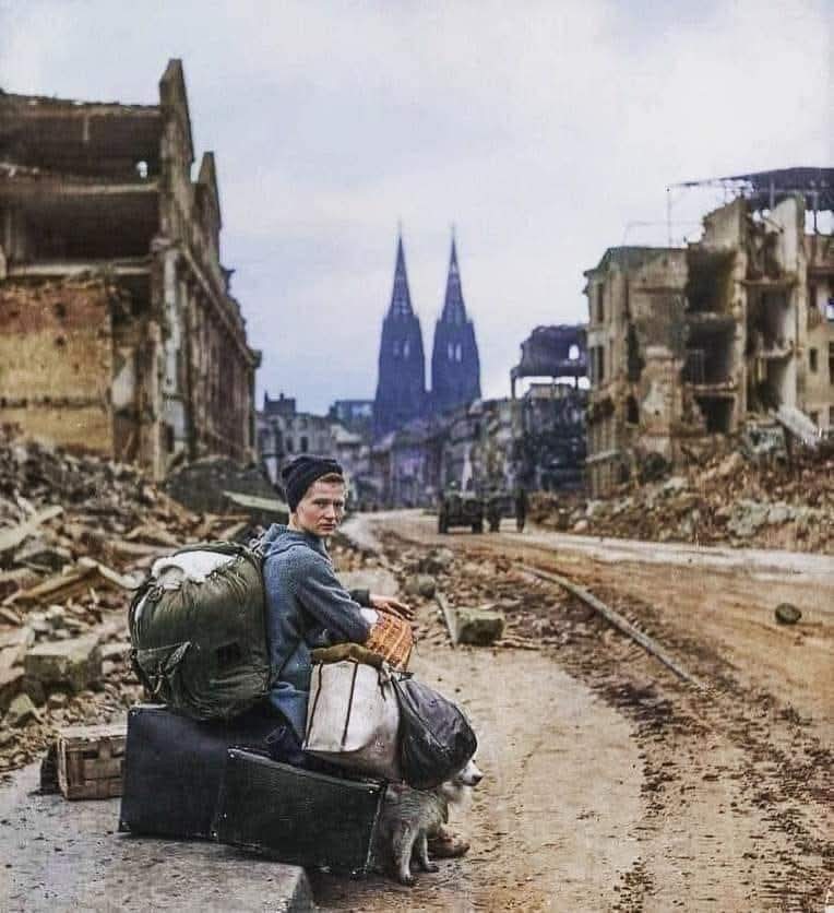 26. A woman with her possessions in the ruins of Cologne, Germany. 1945