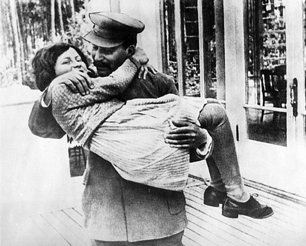 31. Stalin holding and hugging his young daughter , Svetlana