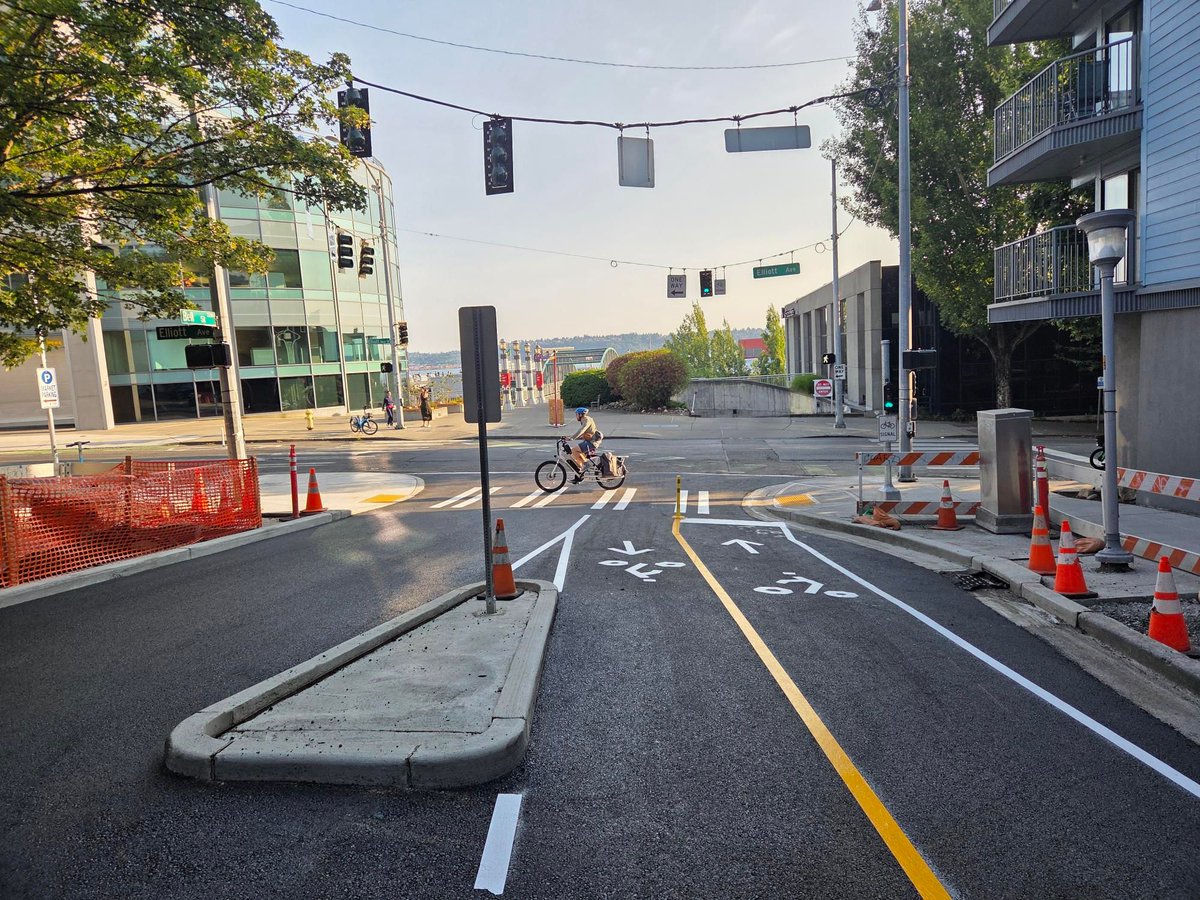 Bell St between Elliott and 1st avenues has reopened with a new two-way bike lane and reconfigured vehicle access! Intermittent daytime closures will be in place as needed to install final elements into July.