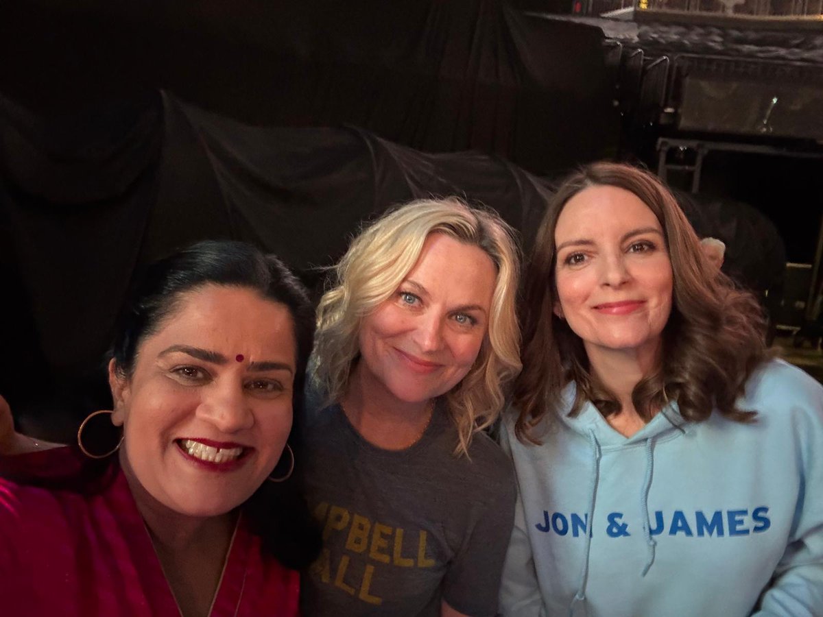 ZarnaGarg's tweet photo. SIXTY shows w the legends! SIXTY!

I opened their first trial show of season 1 in 2023 and closed their last 10,000+ people show of season 2 today!

At one point during this run, Tina had the #1 show on Netflix, Amy had the #1 podcast on Spotify, I had the #1book on Amazon!!! Their greatness rubbed off on me. I haven’t showered since.

We laughed, we cried, our kids had drama, we got sick, had flight issues, it hailed, it stormed, wars broke out literally and figuratively, I got grounded in Oman, their hmu team got held up, book signing stalkers showed up, kids got into college, sitcoms got greenlit, others got passed on, movies got released, books got blurbed, podcasts started and ended, some sandwiches disappointed, some cookies got us excited … so much went on and we pushed through it all.

I can’t believe I got to be on this ride and can’t even contain my excitement for all thats to come. 

Tina and Amy are work friends with each other (they’ve made it very clear) and I’m thrilled to be their third wheeling work apprentice - I would’ve settled for background tree, janitor, accountant even barista on the go (which I’ve now learned is a real job with superstar teams)

I watched and learned and it was the greatest honor of my life.

Shoutout to their entire team A+ all the way! To watch you seamlessly navigate every setback, tantrum, request and more - I now know how to design a real system for myself.

Sorry to the men who came in because their wives dragged them and they ended up having fun despite every attempt not to. We’re sorry you couldn’t leave as grumpy as you started - it happens. That’s life - your blood pressure is lower, you’ll live.

Thank you Tina and Amy!