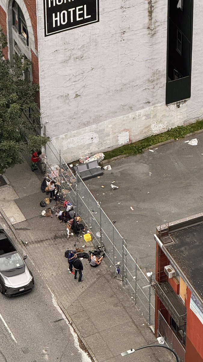 As if it’s not bad enough that the parking lot can’t open because of the drug use and mischief  - somebody has gone and vandalized the fence so they could shove a couch and all garbage into it.