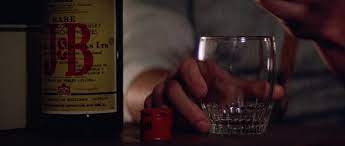 There was a backstory for MacReady. He was a former Vietnam helicopter pilot involved in a tragedy during the war, which left him ashamed and disgrace. Because of this he suffers from PTSD, alcoholism and insomnia. This this explains the drinking scotch from the bottle.

8/37