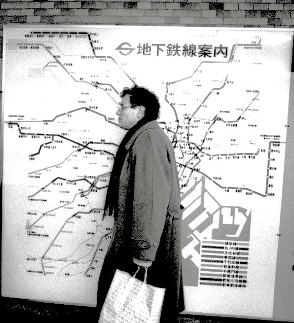 rare pic of Guattari passing a subway map in Japan