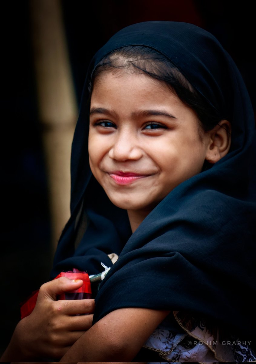 Hope shines through her smile, a Rohingya refugee girl returning from Arabic class.

#Rohingya #Refugee #EducationForAll #Resilience #ArabicSchool #ChildhoodInExile #SmileOfHope
#RohingyaPhotography #RefugeeCamp

Photo: <a href="/CFWRohimUllah/">CFW Rohim Ullah</a>
