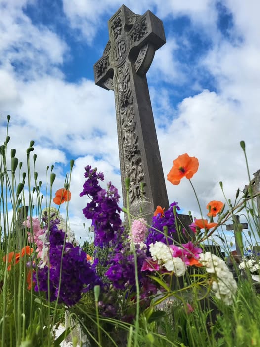We smuggled a vase of flowers in among the poppies on this 'wild' grave.