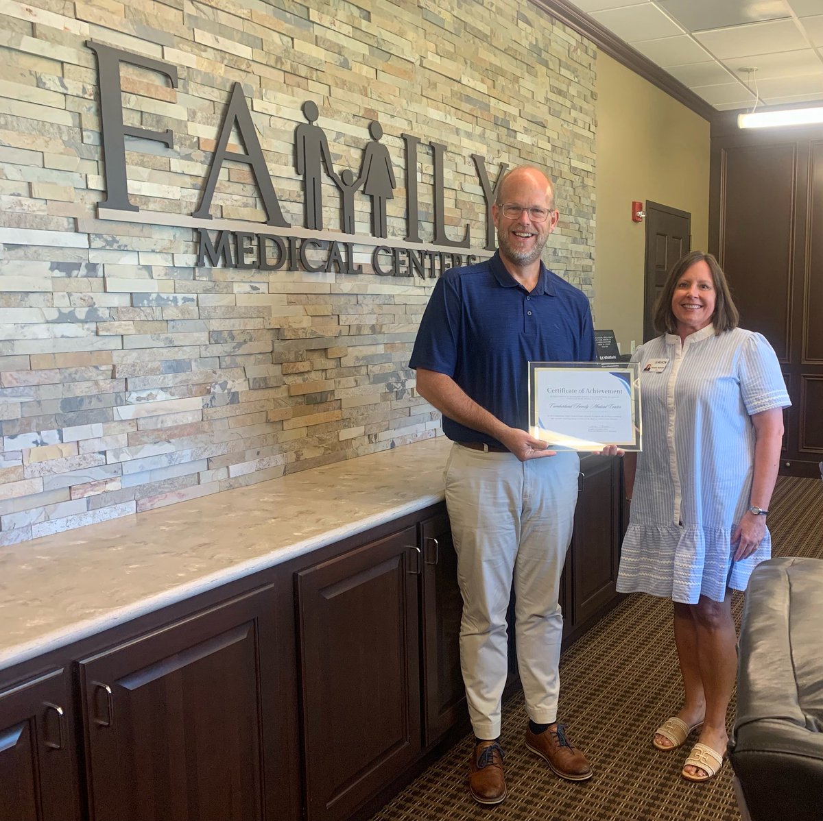 Dr. Eric Loy, CEO of CFMC, accepts an award presented by Jennifer Nesmith, Director of the KY Health Center Network in recognition of CFMC’s achievement in reaching the highest rate of tobacco screening and cessation counseling among all members of the KY Health Center Network.