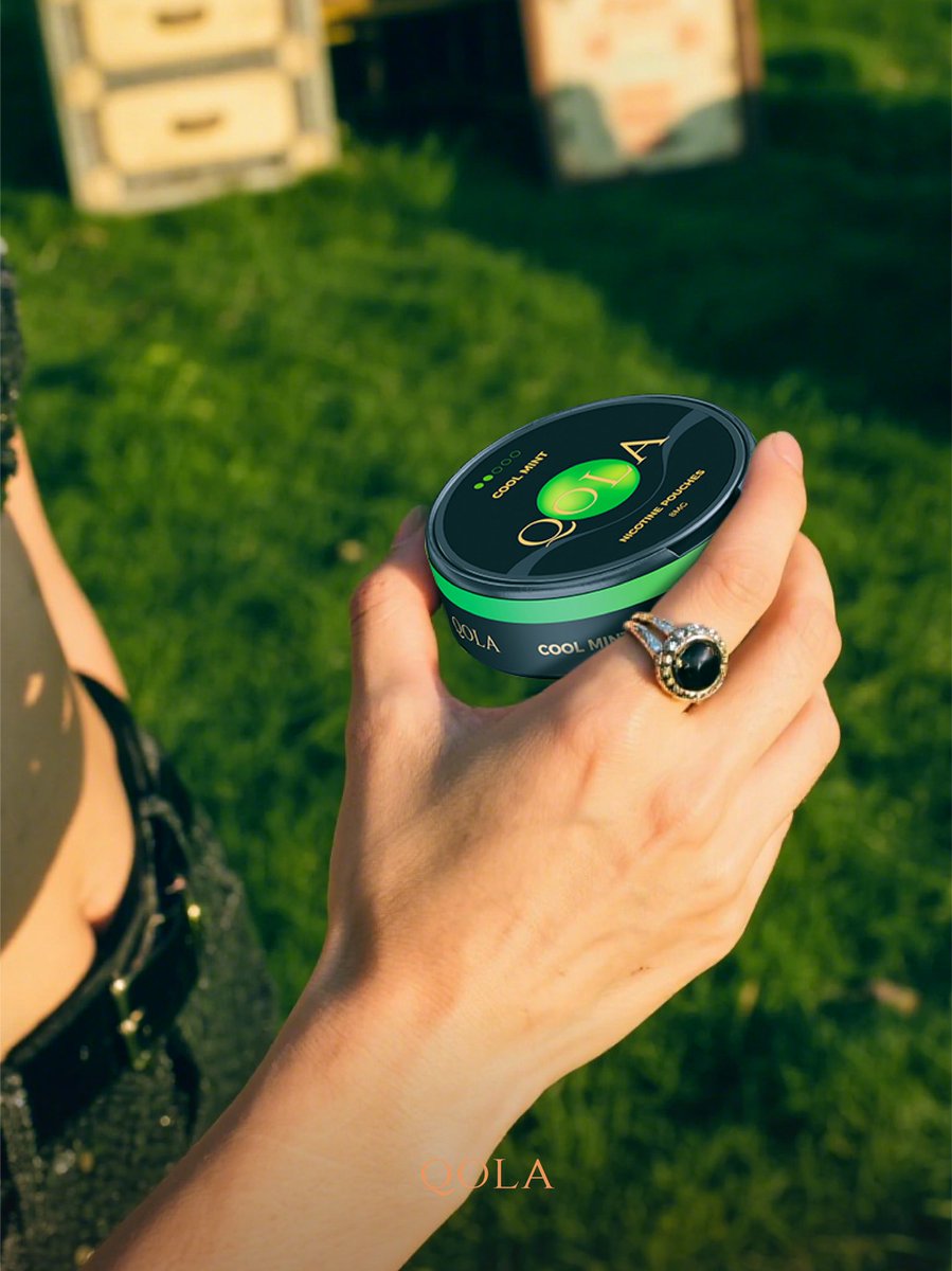 qolapouch's tweet image. Held against the green backdrop, the QOLA COOL MINT can (8mg) feels icy to the touch. Open it: a blast of arctic mint that numbs the tongue slightly, followed by a clean, lingering coolness. 8mg strength—just enough to cut through mental fog, no smoke needed.#QOLA #FrostedMint