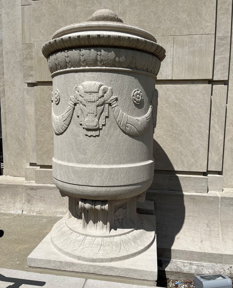 state_library's tweet image. The large stone urns located near the Senate Street door of the Indiana State Library were designed by Leon Hermant and carved by Adolph Wolter. They feature bison heads inspired by the bison on the Indiana state seal. #urns #bison #Indianapolis