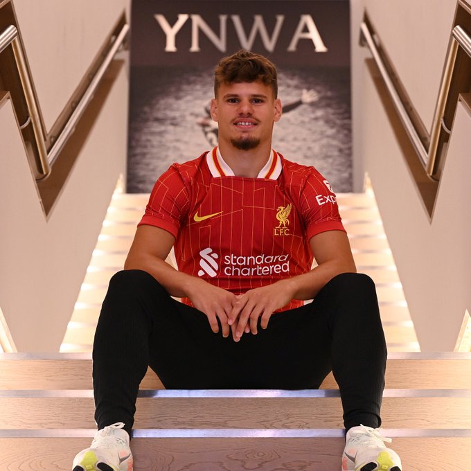 Milos Kerkez sits on stairs with his arms over his knees.