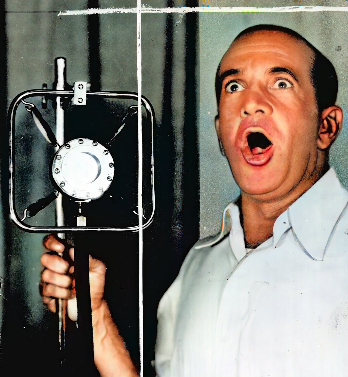 Jolson is doing what he does best: Singing at the top of his lungs. This photo was intended for a magazine. The white lines are lines added by hand by the photo editor. Photo dated 1941, colorized. #jolson #aljolson