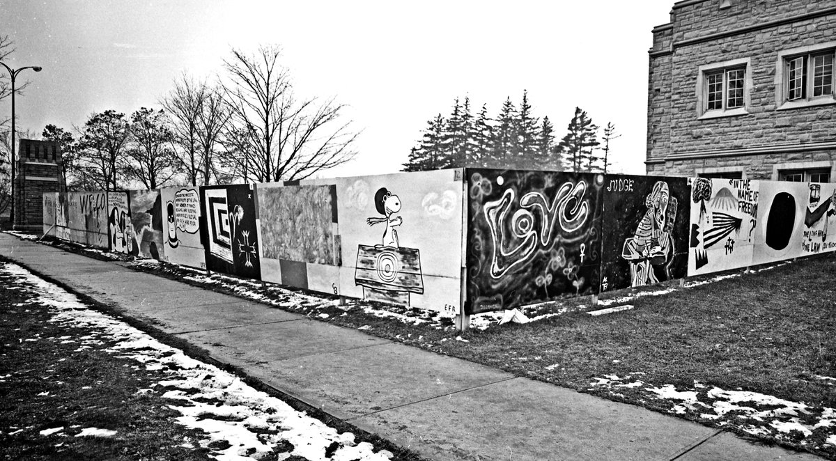 Check out this photo from when an excavation was dug for an addition to the Josephine Niblett Law Building. A wooden fence was built along the sidewalk, and the law student society organized a contest: $25 to the artist with the best design.

Photo from The Way We Were collection