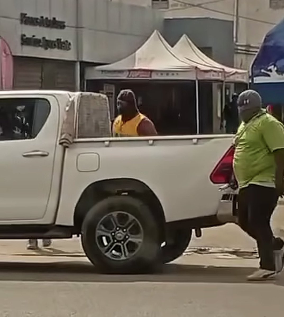 Africarevolt's tweet photo. UNIR militia leader of @FEGnassingbe , hooded, but easily recognizable by his belly. Author of repression against peaceful demonstrators. #FreeTogo #TogoProtests https://t.co/C28xa38imw