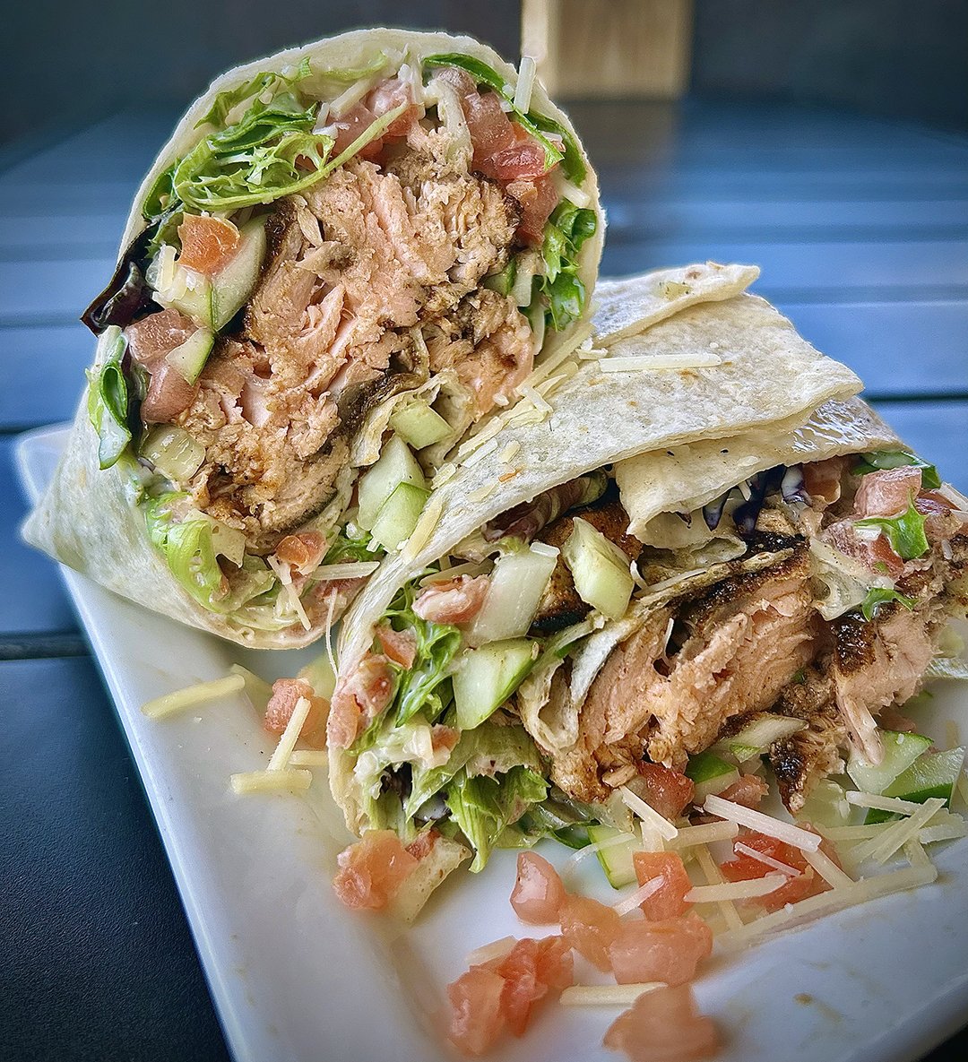 Crow's Nest WEEKLY SPECIAL • 🌯 Blackened Salmon Caesar Wrap 🐟: Grilled salmon, blackened and seasoned, spring mix tossed in house-made Caesar dressing, Grated parmesan, Diced tomato, and cucumber,  in a flour tortilla - $19, with a choice of side. Available through June 27th