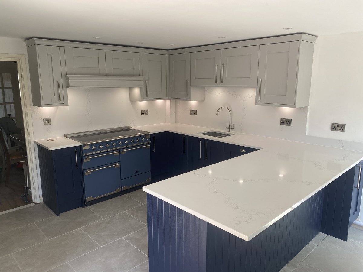 Navy blue &amp; light grey shaker kitchen with bespoke canopy and quartz worktop and wall cladding @NEFFHomeUK <a href="/1810co/">The 1810 Company</a> <a href="/RangemasterUK/">Rangemaster</a> by <a href="/KBKITCHENS/">KB Kitchens & Interiors</a>