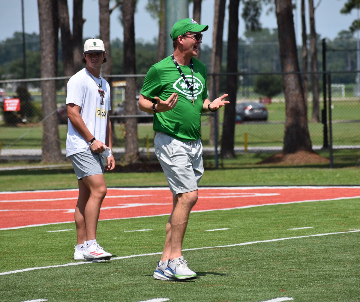 Pro Football Hall of Famer Peyton Manning leading drills to begin the Manning Passing Academy throwing session with the Camp Counselors.