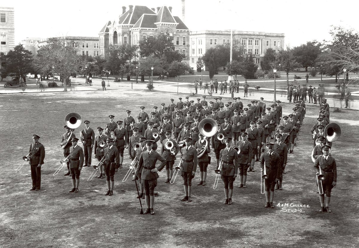 Holy smokes! Check out this 1920 photo of the Texas Aggie marching band.  The street behind the band is Military Walk. To the left of the ornate building in the center is Leggett Hall.  Also, I notice that they are wearing leggings as opposed to boots. Such a great shot. So clear