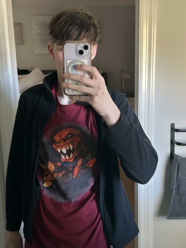 ScrappySlowbro's tweet photo. I had just so many things that i decided id limit what id show to just shirts, some promos and my plushie. Couldnt find war when i took this photo but luckily i have a photo of me with War on. I love Four souls sm thanks for all the cool stuff @TheMaestroTeam #DeathDrawsNear https://t.co/ADFUaYkuUV