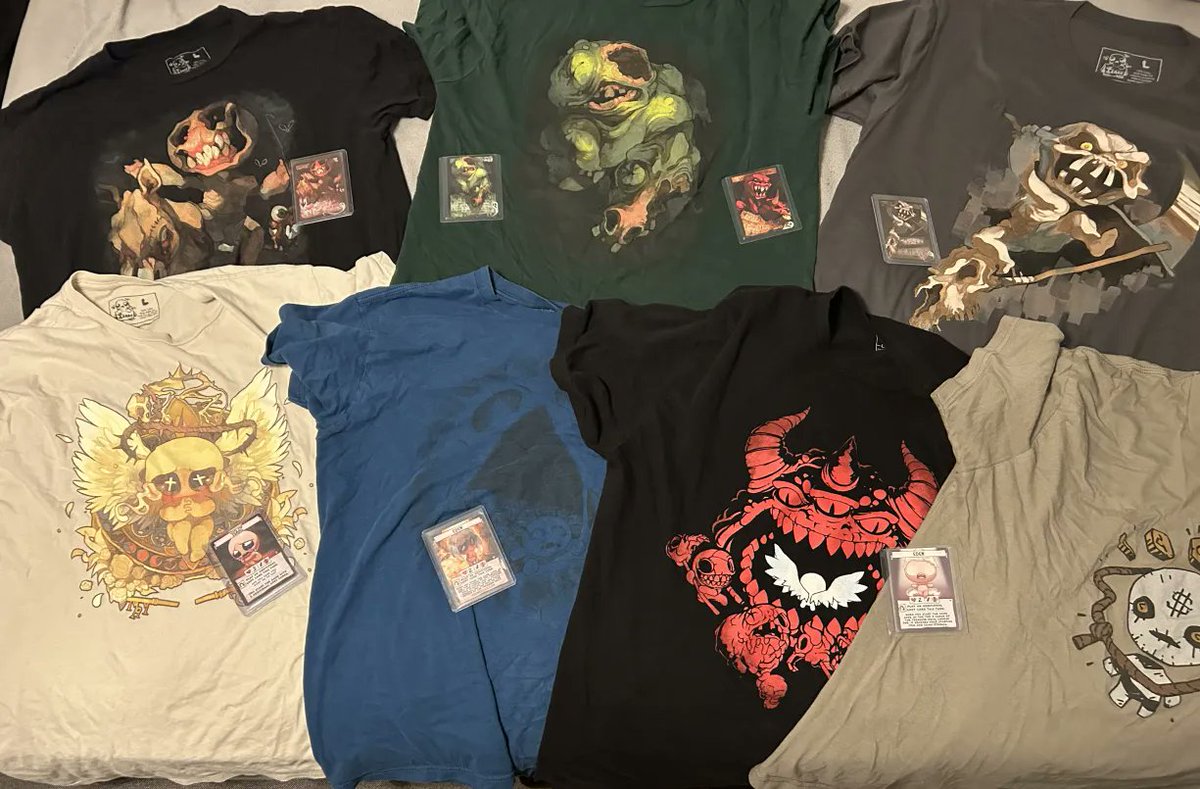 ScrappySlowbro's tweet photo. I had just so many things that i decided id limit what id show to just shirts, some promos and my plushie. Couldnt find war when i took this photo but luckily i have a photo of me with War on. I love Four souls sm thanks for all the cool stuff @TheMaestroTeam #DeathDrawsNear https://t.co/ADFUaYkuUV