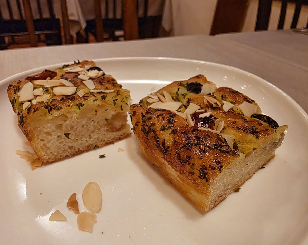BournbonL24096's tweet image. Focaccia – Italy’s plain soul.  
Focaccia, born in Liguria, is Italy’s ancient bread. From the Latin “focus,” meaning hearth, it was baked on hot stones or in wood ovens in Roman times.  
#Focaccia #ItalianBread #Liguria #MediterraneanFlavors