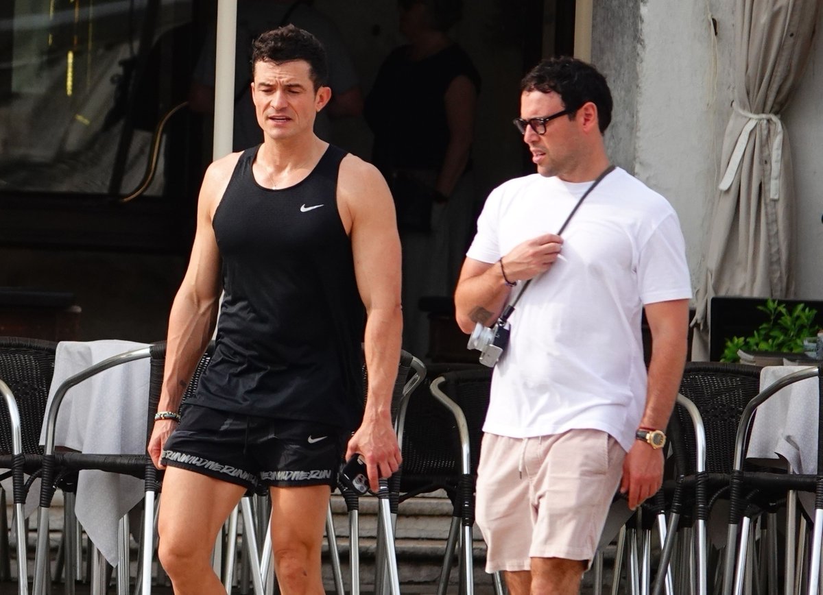 Muscular Orlando Bloom and Scooter Braun hanging out before Jeff Bezos &amp; Lauren Sanchez's wedding amid Katy Perry split reports.