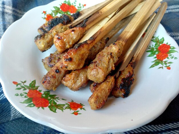Balinese Chicken Sate.  Different from the typical Sate as it is not pieces of chicken, but ground chicken  that is shaped and placed on a flat skewer and it is slightly spicy. Our Lunch, minutes ago. #Foodies