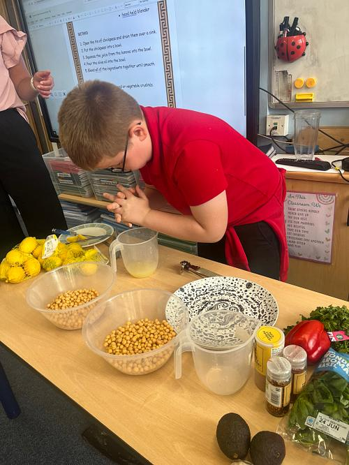 Class 12
The children making their hummus this afternoon! They got to add their own flavours- some very interesting choices! Well done to everyone.